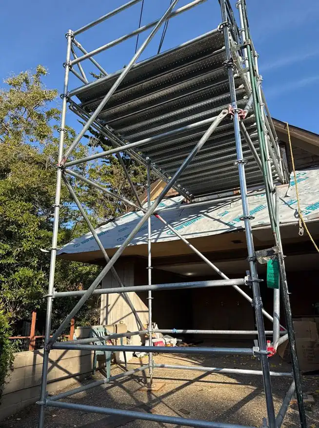 Garage-front scaffold tower installed by OC Elite Scaffolding for roof and exterior repairs